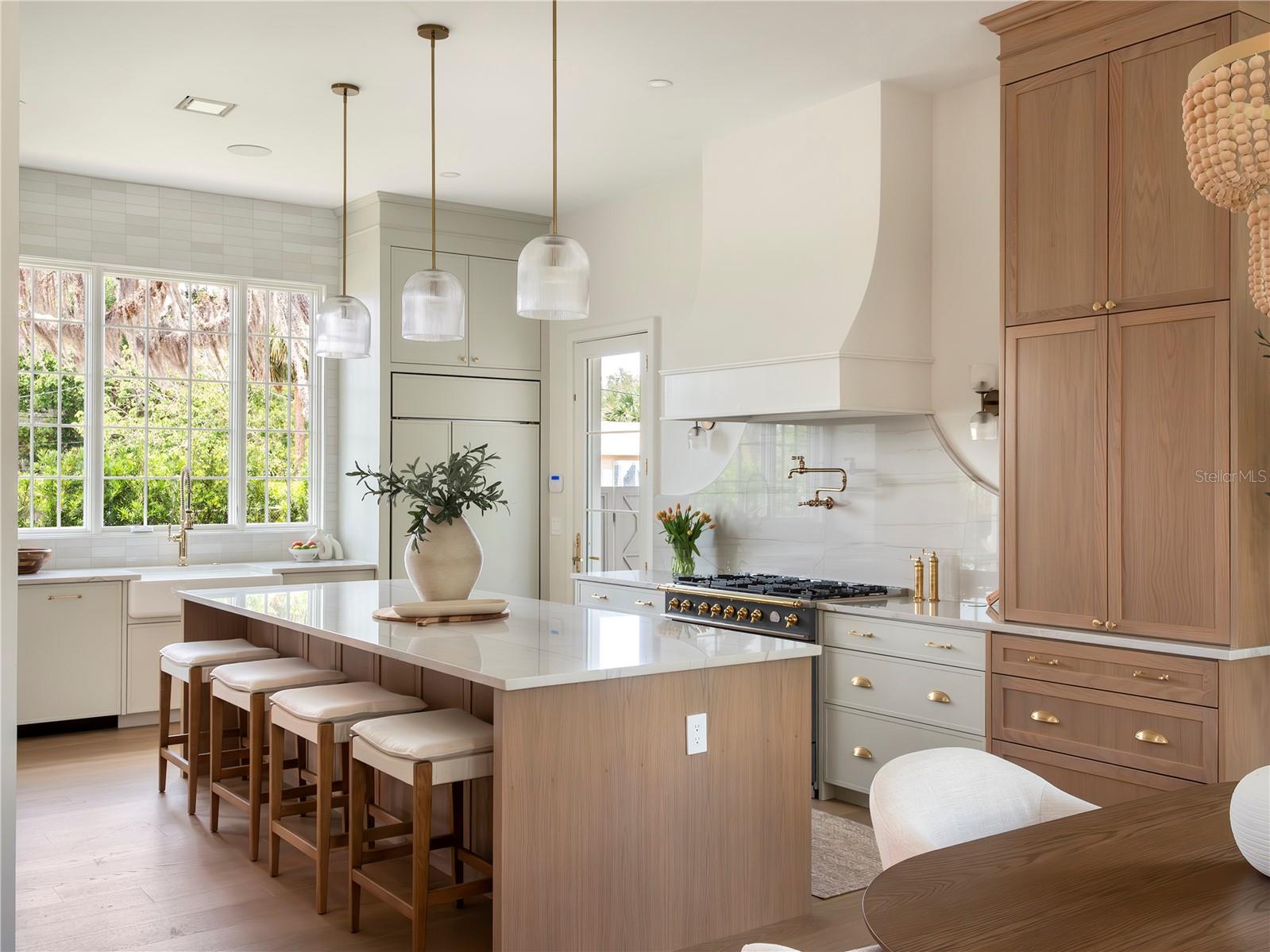 Kitchen with grand center island and plaster hood
