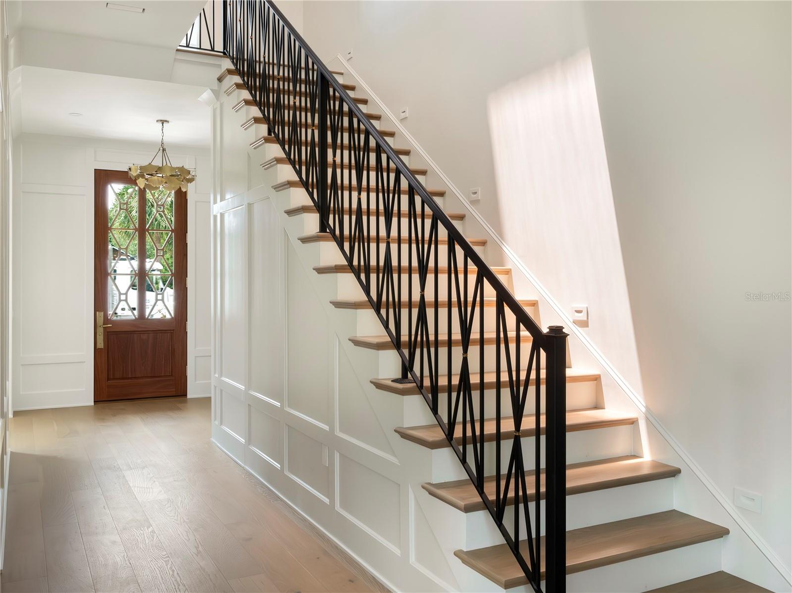 Custom staircase with wrought iron railing